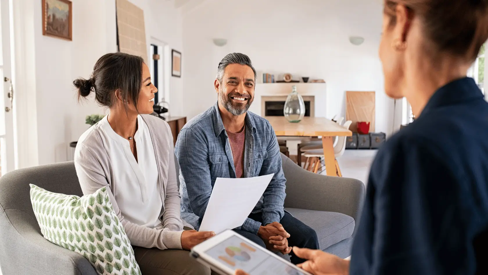 Three trusted advisors in a collaborative planning huddle around a conference table