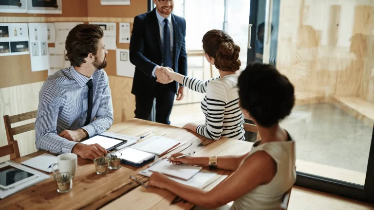 Business owner and advisors in a professional meeting discussing financial strategy and business confidence