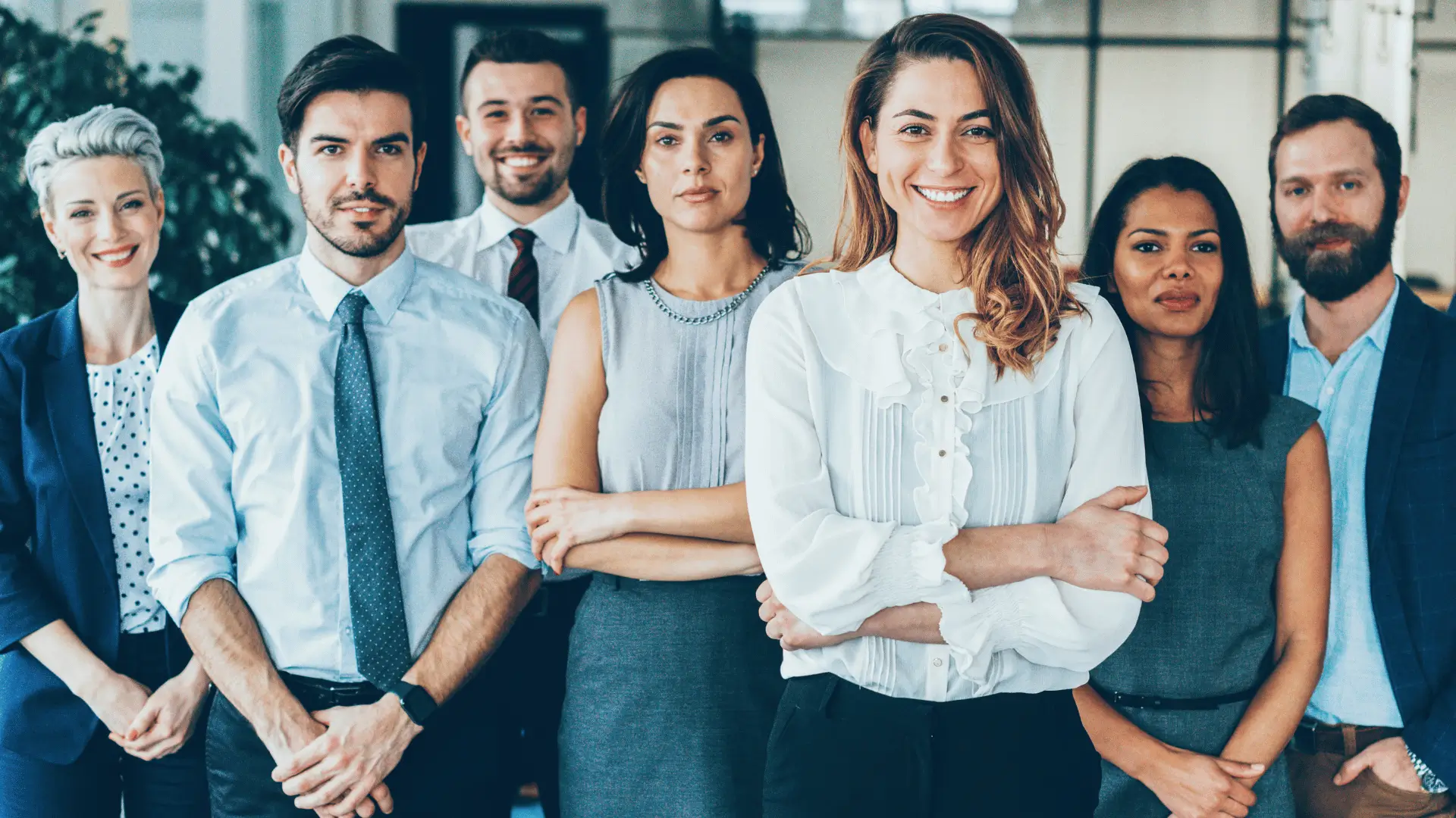 Six diverse allied professionals standing together representing coordinated expert team
